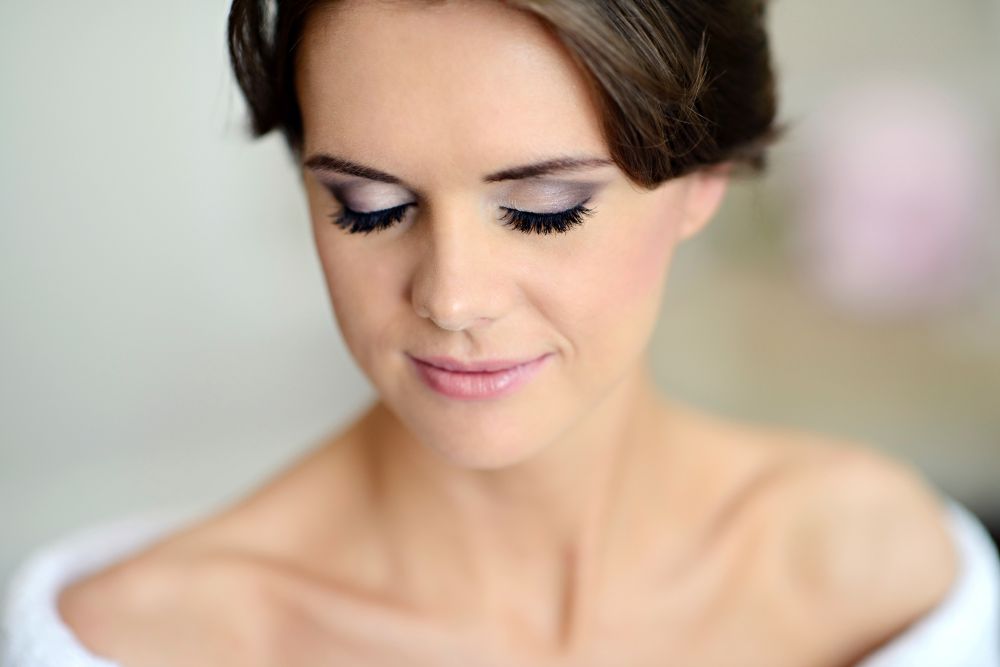 Client receiving a facial treatment with groomed brows and enhanced lashes at a NYC beauty salon