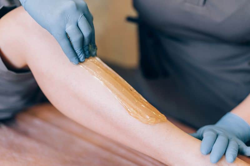 Client with glowing smooth skin after organic sugaring hair removal in NYC